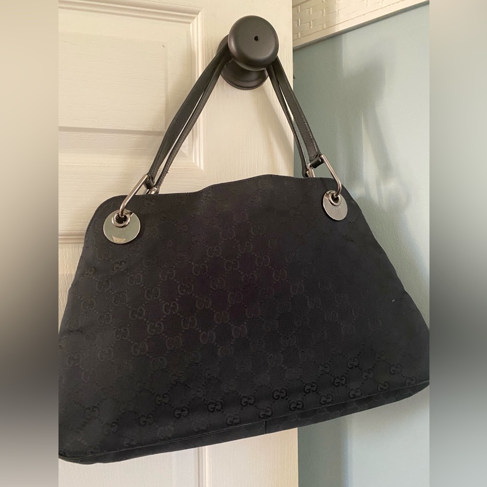 This GUCCI Eclipse GG Canvas Bag -Black is likely used good condition .